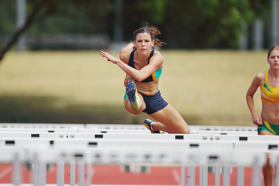Athlete clearing hurdles under pressure