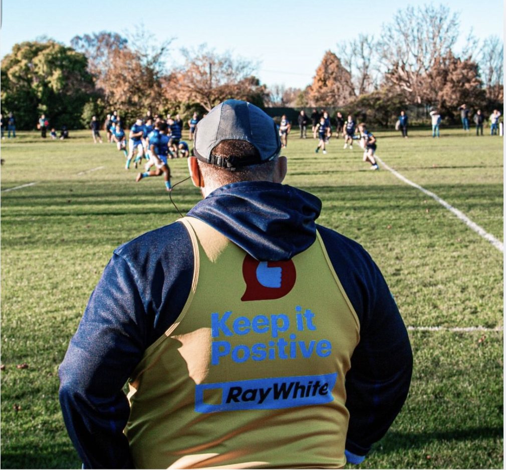 A coach watching from the sideline
