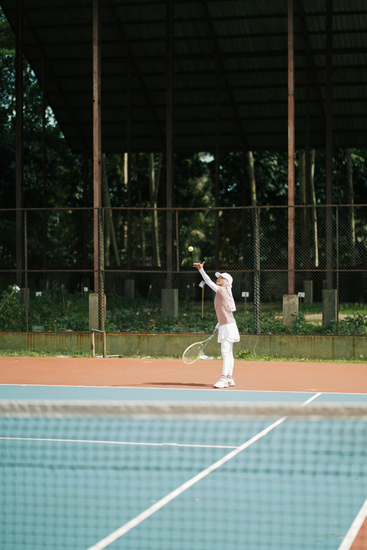 A junior tennis player mid-match